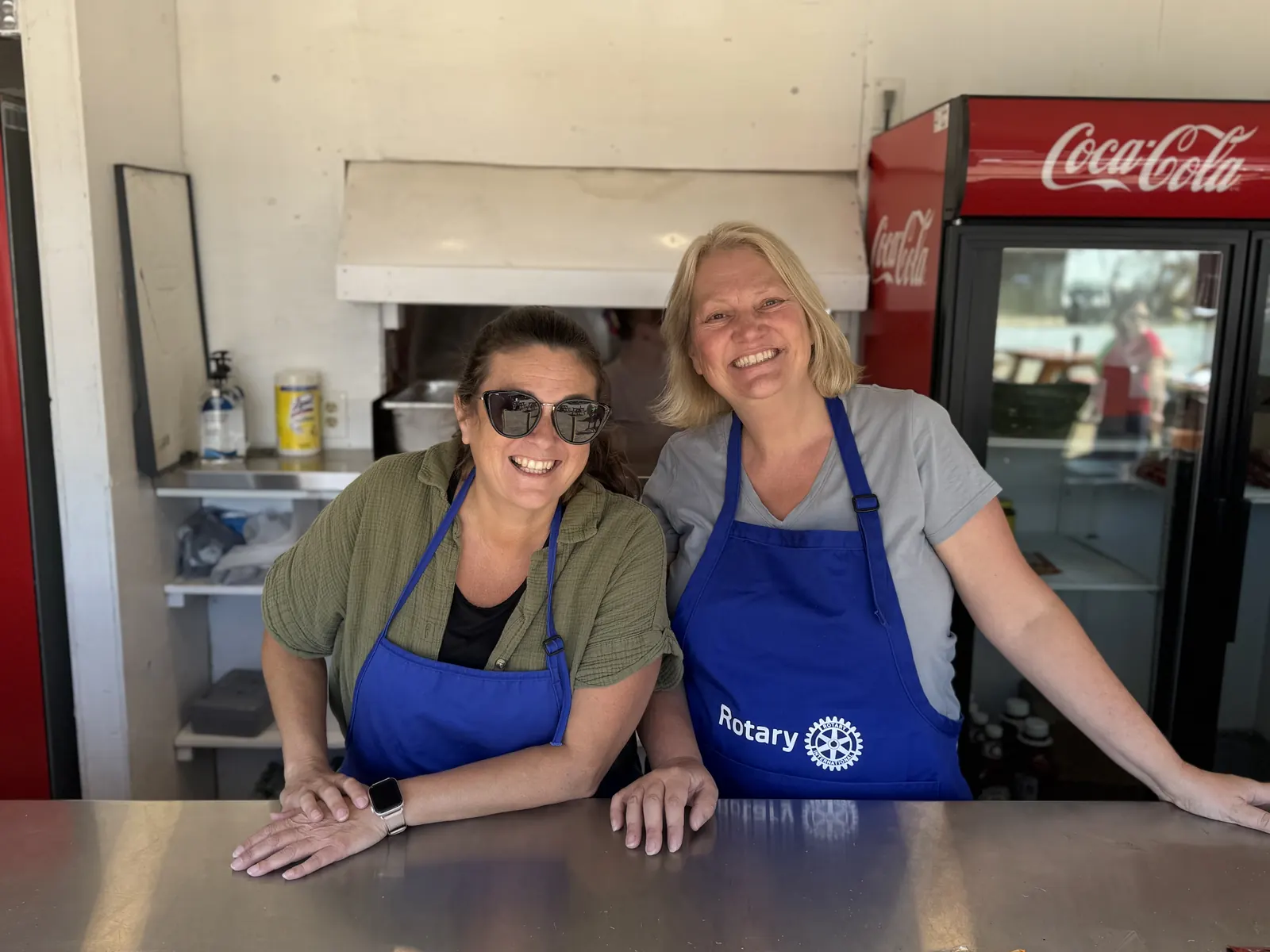 Two members smiling at the concession window