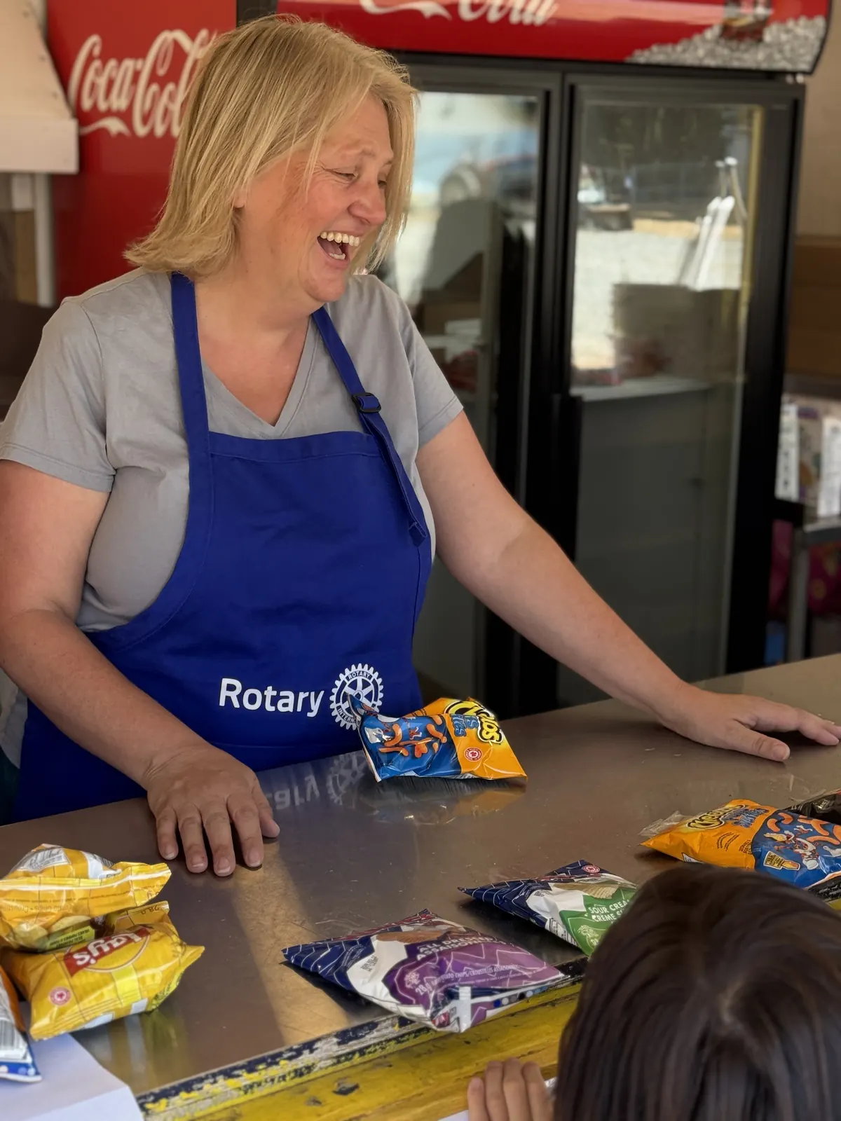 A member laughing behind the concession counter